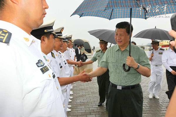 资料图：习近平冒雨登上辽宁舰。