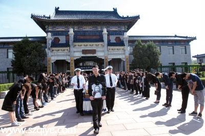      追悼会后，周云露的哥哥手捧妹妹的遗像走出灵堂，亲友及同学鞠躬送别。